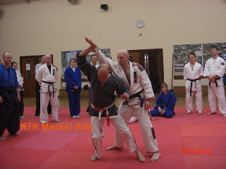 Sensei Mick Grime from Darwen demonstrates on Sensei Phil Hargreaves.