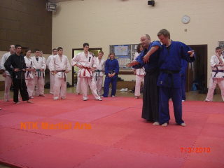 Sensei David Milenkovic demonstrates on Sensei Carlton.