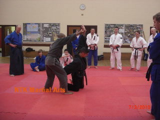 Sensei Joao  teaching on the Seminar accompanied by Helder.